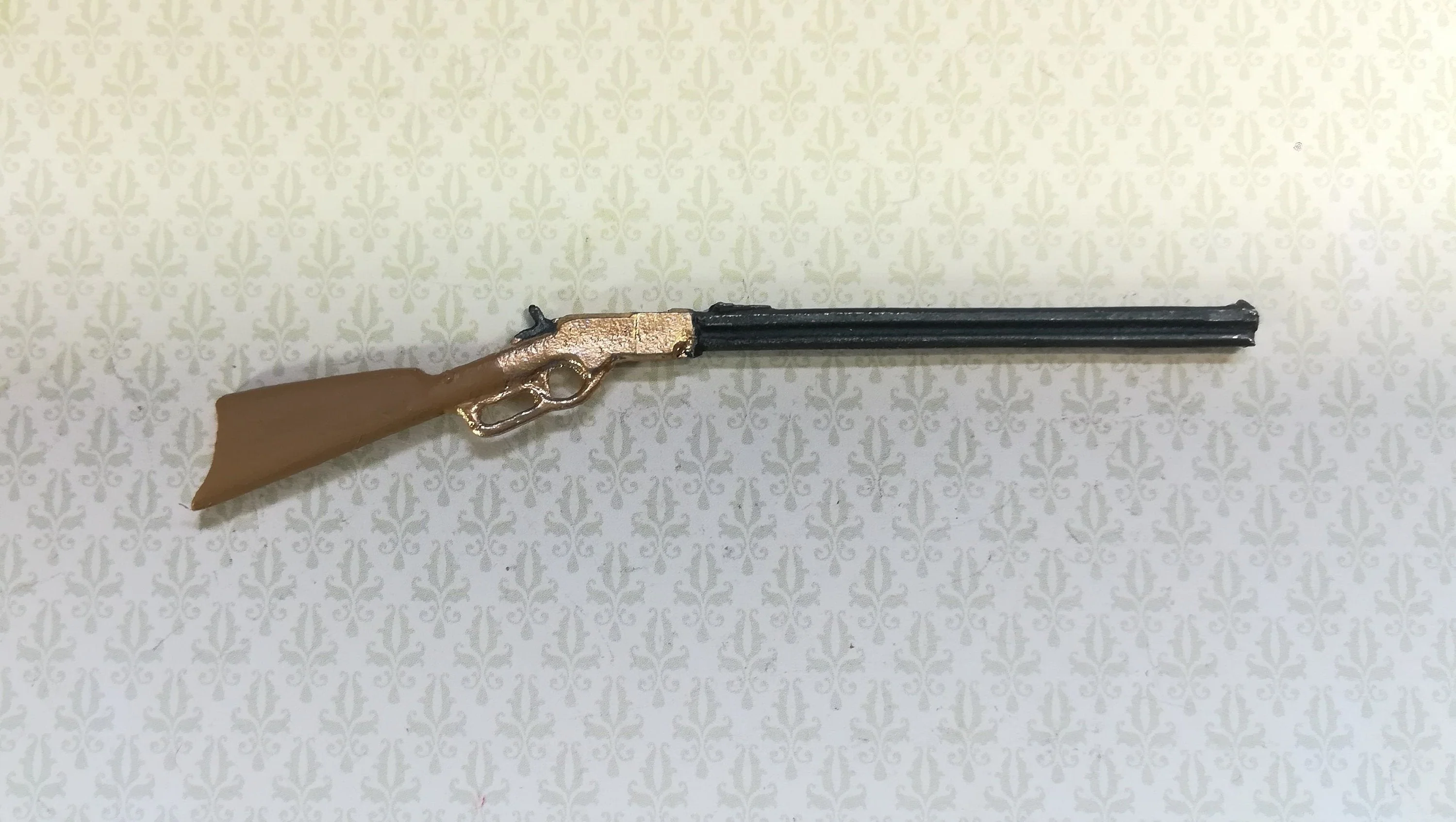 Dollhouse Winchester Rifle measuring 3.5" long (8.8 cm) Painted metal, brown stock with gold action by Island Craft Miniatures
